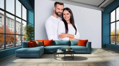 Photo of cute young couple embrace wear white shirt isolated on grey color background Wall mural