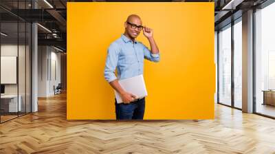 Photo of dark skin guy notebook hands classroom young school teacher wear specs jeans denim shirt isolated bright yellow background Wall mural