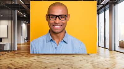 Photo of dark skin macho attractive appearance not smiling conference wear specs jeans denim shirt isolated bright yellow background Wall mural