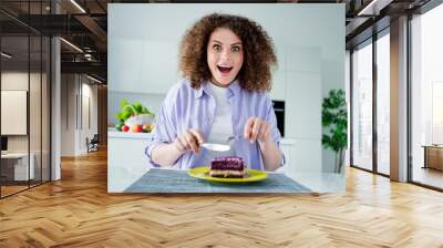 Photo of excited funky lady dressed purple shirt enjoying sweet tasty berry pie indoors house kitchen Wall mural