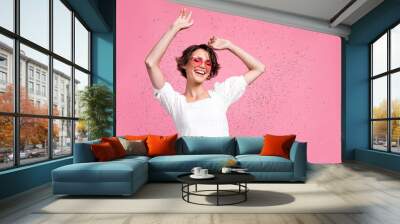 Photo of excited pretty girl dressed white top heart eyewear having fun empty space isolated pink color background Wall mural