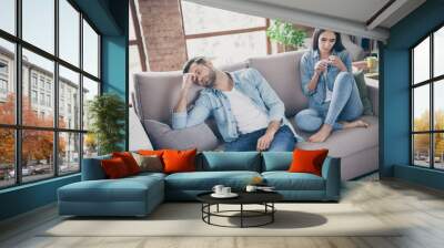 Photo of frustrated quarantine couple sit couch feel boring man sleep woman look manicure in house indoors Wall mural