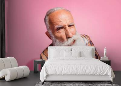 Photo of funny grandfather confused face eavesdrop tiger print shirt isolated on pink color background Wall mural