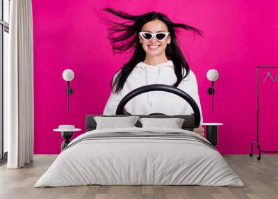 Photo of funny lady hold steering wheel driver license exam concept wear white sweatshirt isolated pink color background Wall mural