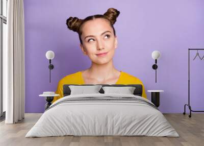 Photo of funny pretty lady youngster looking up empty space having crazy but smart idea wear yellow t-shirt isolated on pastel purple background Wall mural