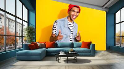 Photo of glad funky man wear modern outfit two arms showing you invite join cool party isolated on yellow color background Wall mural