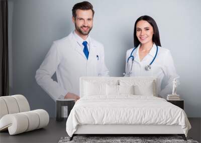 Photo of handsome doc guy practitioner experienced professional pretty lady two people patients consultation virology clinic good mood wear lab coats isolated grey color background Wall mural