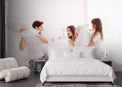 Photo of happy family mommy daddy daughter sheets good mood having fun spend together quarantine weekend playing games pillow fight self isolation offspring bedroom indoors Wall mural