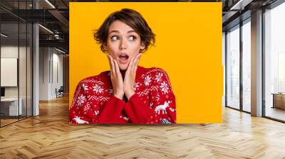 Photo of impressed girl with bob hairstyle dressed red sweatshirt palms on face staring at empty space isolated on yellow color background Wall mural