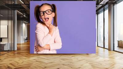 Photo of intelligent dreamy creative girl look empty space wear glasses hold finger chin isolated on violet color background Wall mural