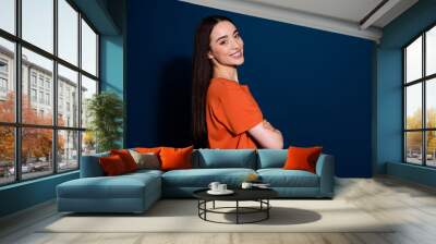 Photo of lovely adorable positive woman wear stylish clothes folded arms empty space isolated on dark blue color background Wall mural