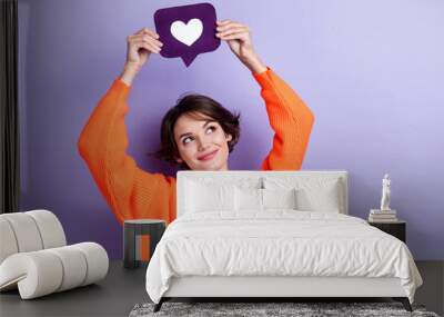 Photo of lovely pretty lady wear stylish clothes arm hold social media like under head look empty space isolated on purple color background Wall mural