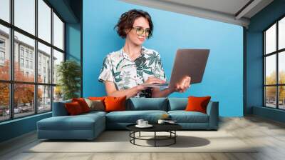 Photo of lovely smart nice girl with bob hairstyle dressed colorful blouse look at laptop read email isolated on blue color background Wall mural