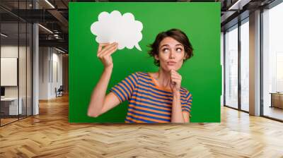 Photo of minded creative person arm touch chin look empty space cloud shape card isolated on green color background Wall mural