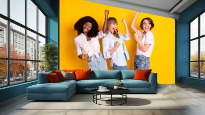 Photo of nice hooray three ladies yell wear white shirt isolated on bright yellow color background Wall mural