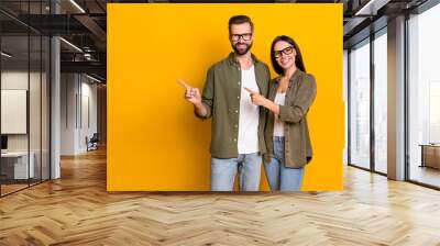 Photo of nice young brunette people index promo wear glasses shirt isolated on yellow color background Wall mural