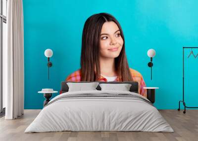 Photo of nice young girl look empty space wear plaid shirt isolated on teal color background Wall mural