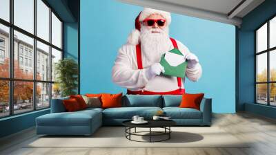 Photo of pensioner old man grey beard hold envelopes unboxing received letter curious want read wear santa costume suspenders sunglass white gloves cap isolated blue color background Wall mural