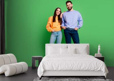 Photo of positive charming happy couple wear stylish outfit isolated on green color background Wall mural