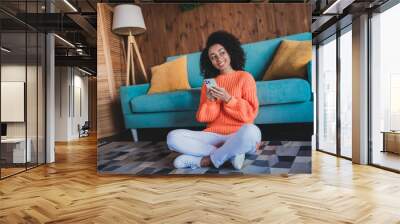 Photo of positive good mood woman dressed orange pullover relaxing home communicating modern device indoors house apartment room Wall mural