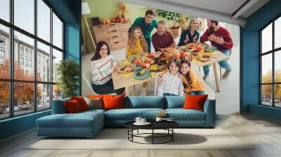 Photo of positive people happy big family celebrating thanksgiving day sitting eating turkey indoors room home Wall mural