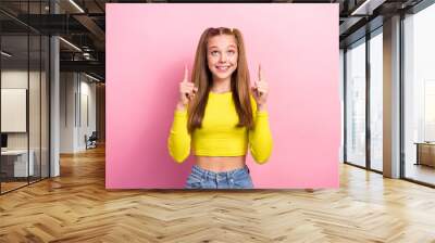 Photo of positive pretty lady two arm direct empty space interested look cool offer proposition promo isolated on pink color background Wall mural