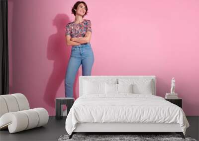 Photo of pretty adorable cute girl wear stylish clothes crossed arms look blank space isolated on pink color background Wall mural