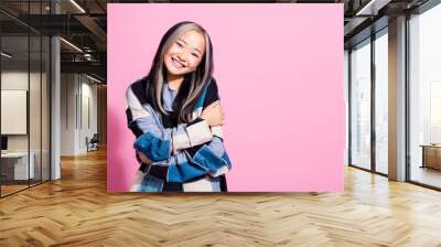 Photo of pretty cheerful lady toothy smile arms hug shoulders empty space isolated on pink color background Wall mural