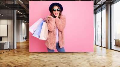 Photo of pretty lady hold carry many packs shopper tourism abroad look unbelievable sale prices hand on cheek store wear jacket sun specs hat jeans isolated pink background Wall mural