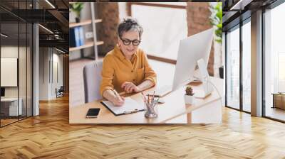 Photo of pretty retired woman signing contract dressed yellow formalwear modern workplace working home distance office Wall mural