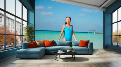 Photo of pretty tender girl enjoy luxury weekend exotic resort swim hot water under blue sky walk go wear bodysuit Wall mural