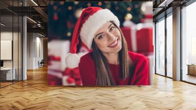 Photo of pretty young girl toothy beaming smile wear santa cap red sweater in decorated x-mas living room indoors Wall mural