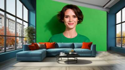 Photo of satisfied glad person smile look camera isolated on green color background Wall mural