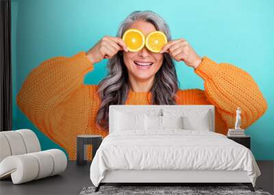 Photo of senior lovely woman have fun cover eyes citrus good mood hiding playful isolated over teal color background Wall mural