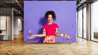 Photo of shiny attractive lady dressed pink t-shirt catching sparkles empty space isolated purple color background Wall mural