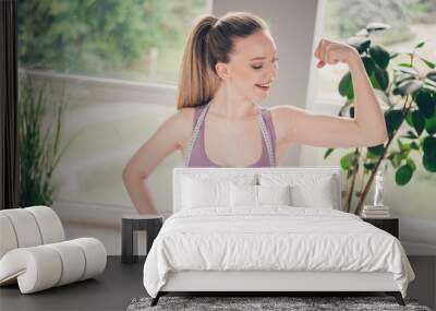 Photo of sporty strong active girl showing arm biceps triceps training exercises house indoors Wall mural