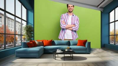 Photo of successful young ceo executive director folded arms confident happy smile high income company isolated on green color background Wall mural