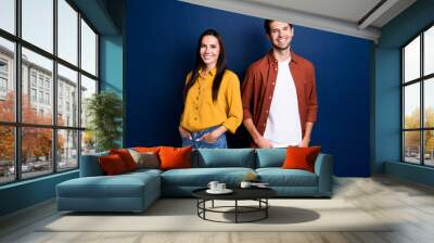 Photo of two cheerful corporate people toothy smile put hands pockets posing isolated on dark blue color background Wall mural