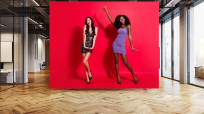 Photo of two dreamy shy ladies dance look empty space wear mini dress stilettos isolated red color background Wall mural