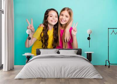 Photo of two excited cheerful nice cute girls showing you v-sign while isolated with teal background Wall mural