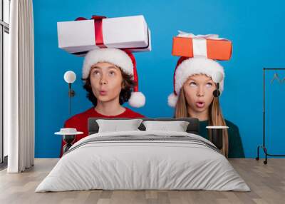 Photo of two kids have christmas gifts head look feel surprise isolated blue color background Wall mural