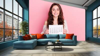 Photo of young attractive girl happy positive smile hold calendar day month time isolated over pastel color background Wall mural