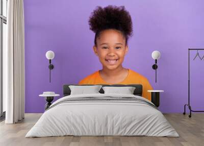 Photo of young cheerful little afro girl happy positive toothy smile isolated over violet color background Wall mural