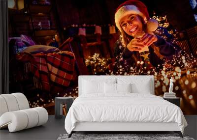 Photo of young girl lying floor drink milk dressed christmas garment enjoy garland light cozy x-mas party decoration interior flat indoors Wall mural