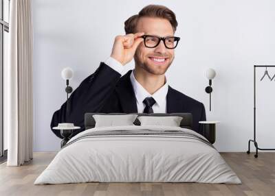 Photo of young handsome man happy positive smile hand touch glasses look empty space isolated over grey color background Wall mural