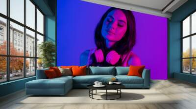 photo of young happy lovely stunning girl with headphones closed eyes dreaming isolated on neon vibr Wall mural