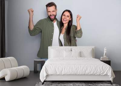 Photo of young two cheerful people celebrate success fists hands triumph isolated over grey color background Wall mural