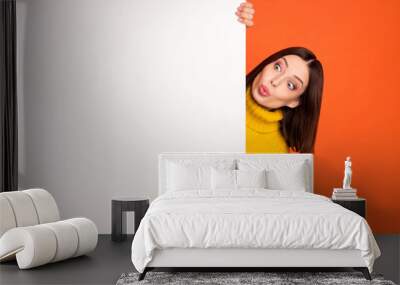 Photo of young woman amazed shocked look empty space blank poster advertise news isolated over orange color background Wall mural