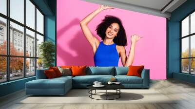 Photo portrait of attractive young woman point empty space dressed stylish blue clothes isolated on pink color background Wall mural