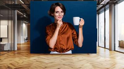 Photo portrait of attractive young woman touch chin tasty coffee dressed stylish brown blouse isolated on dark brown color background Wall mural